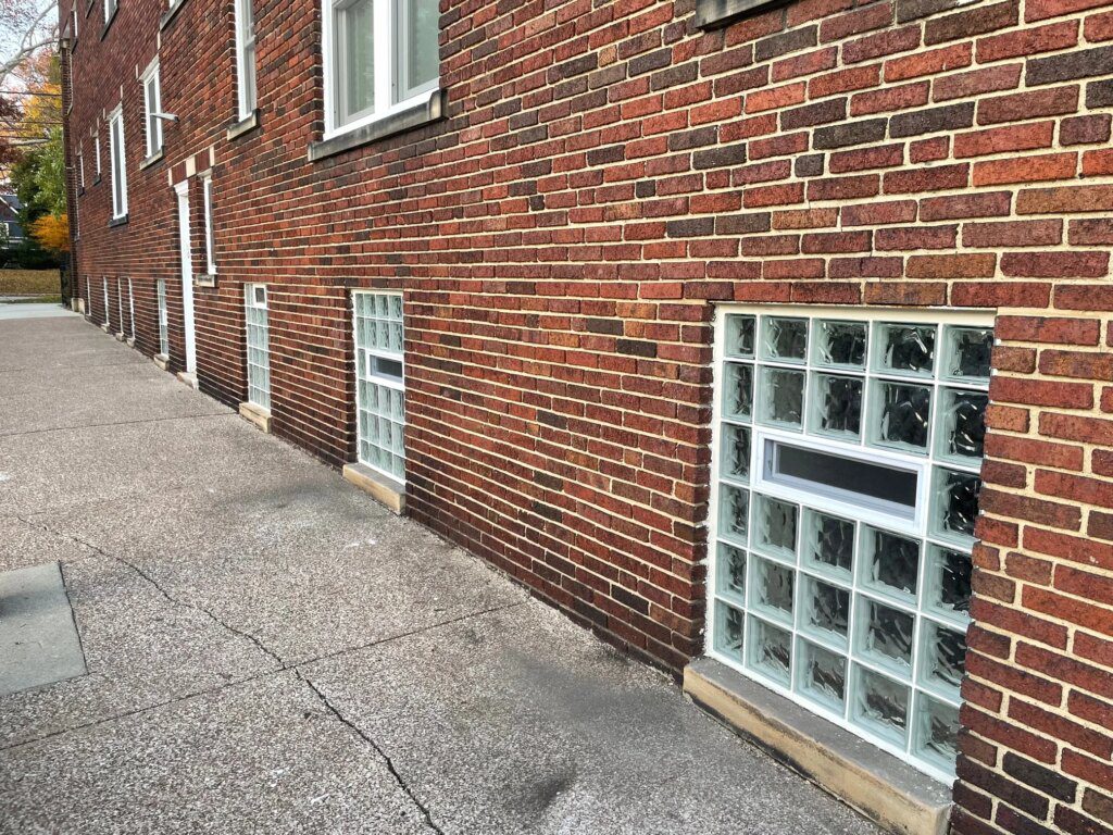 Vented glass block basement windows in red brick building