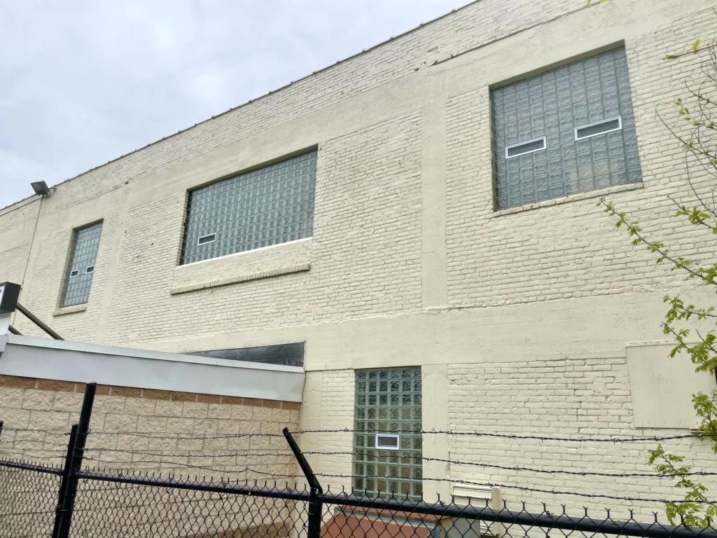 Vented glass block windows on a painted brick industrial building