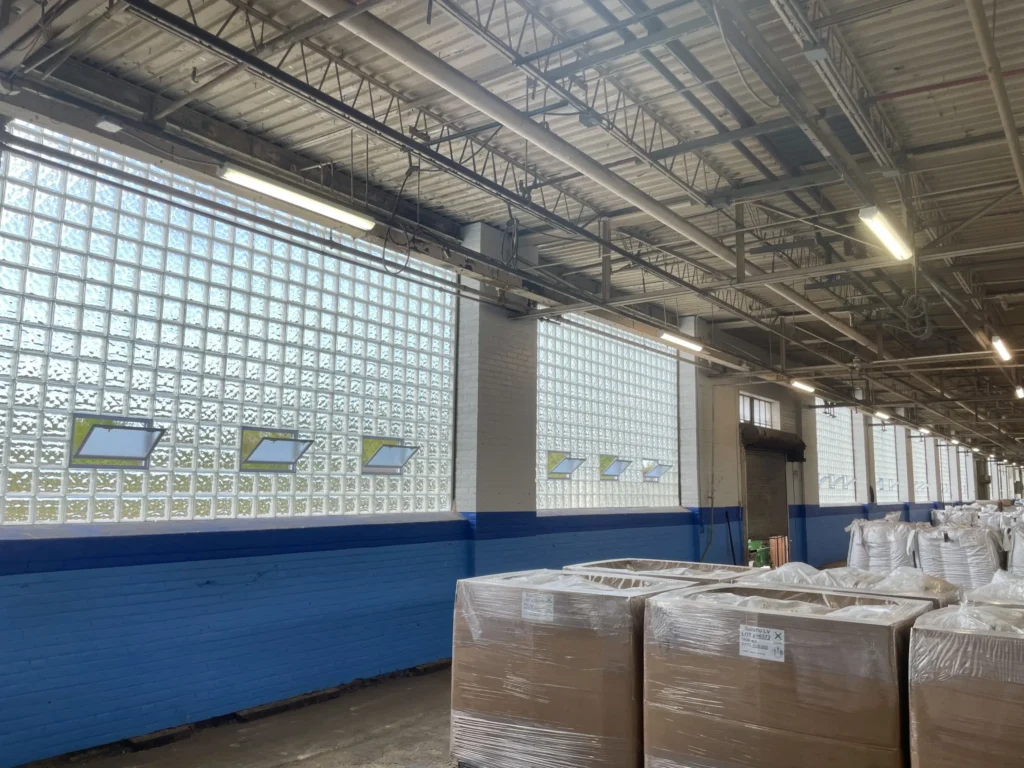Warehouse interior with large vented glass block window walls