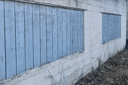 Pool company warehouse boarded openings before glass block installation
